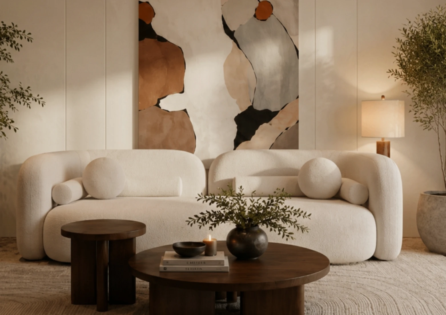 Curved bouclé sofas with sculptural cushions and abstract art